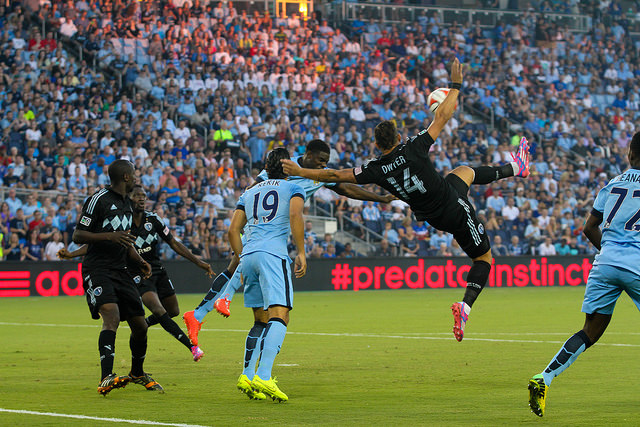 Dom Dwyer attempts bicycle kick against Manchester City defense. Photo by Michael Alvarado