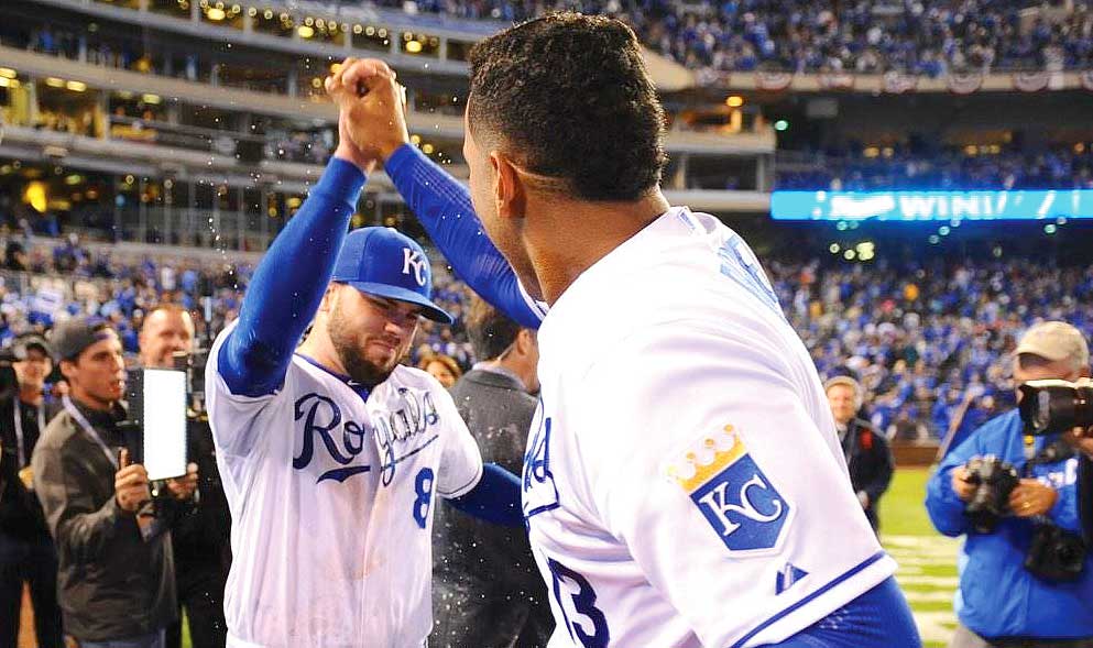 Mike Moustakas celebrates with Salvador Perez